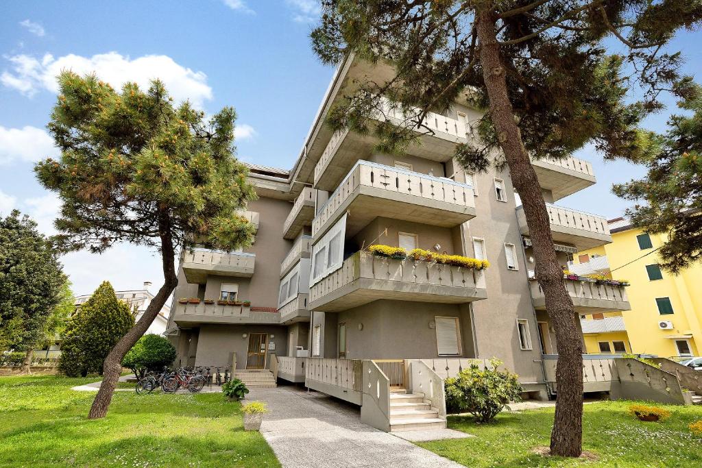 a large building with trees in front of it at Mansarda di Ponente in Caorle