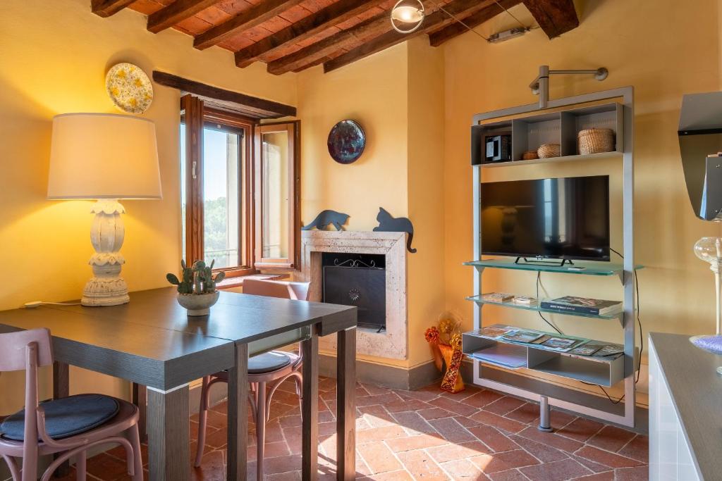 a living room with a table and a fireplace at Small Rustic Apartment in Scrofiano
