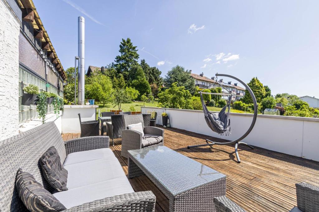 a patio with furniture and a swing on a roof at My Cocoon in Lüdenscheid