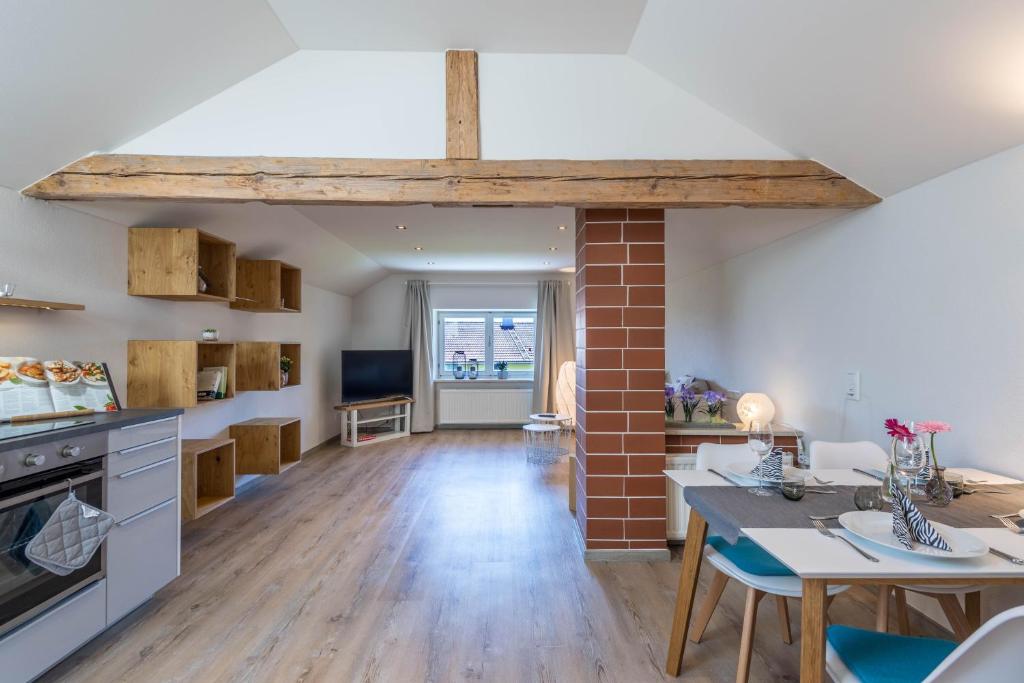 a kitchen and living room with a brick wall at Ferienwohnung Linde in Taching am See