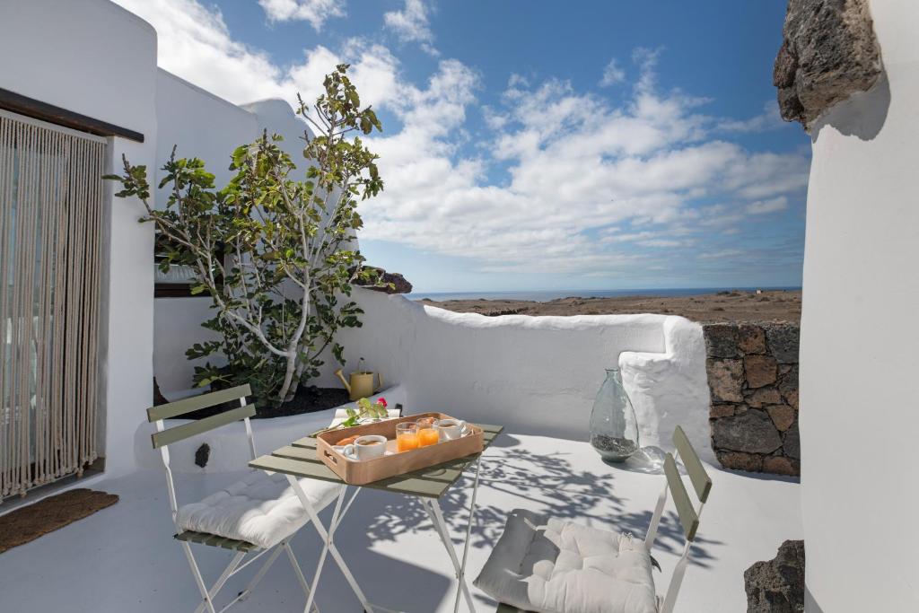 a table with a bowl of fruit on a balcony at Apartamento Pitaya in Arrecife