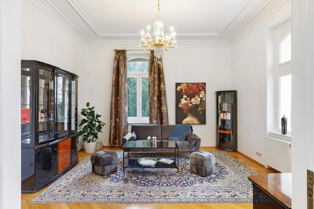 a living room with a couch and a table at Villa am Weinberg in Wiesbaden