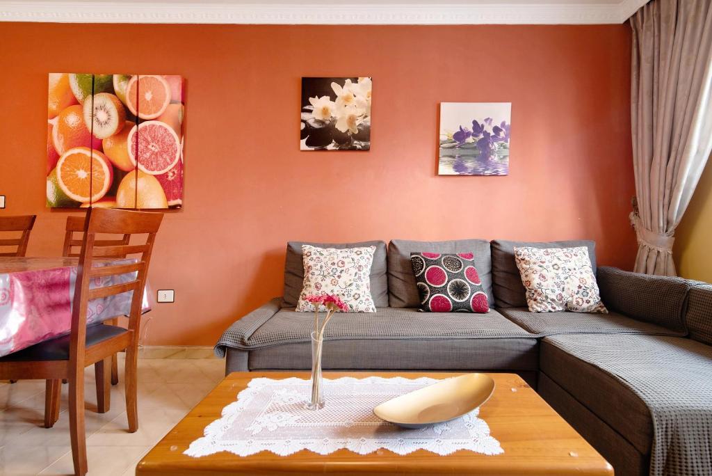 a living room with a couch and a table at Costamar Arinaga in Arinaga