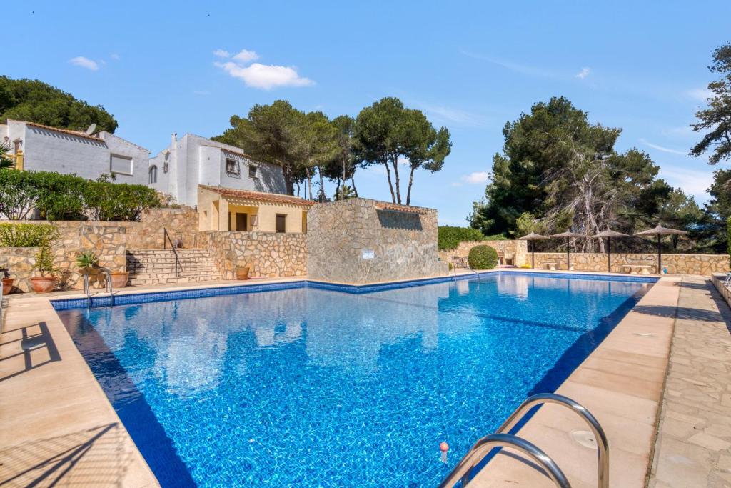 a swimming pool in a villa with a house at La Finca Moraira in Teulada