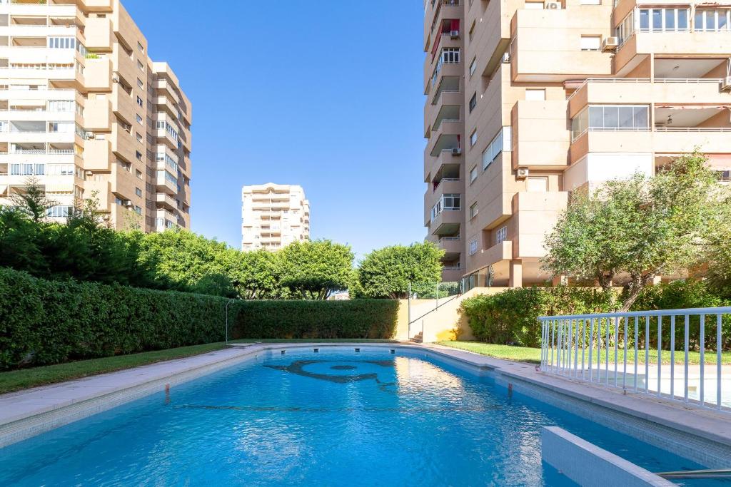 a swimming pool in an apartment with buildings at Apartamento Calle Ciruelo in Aguadulce