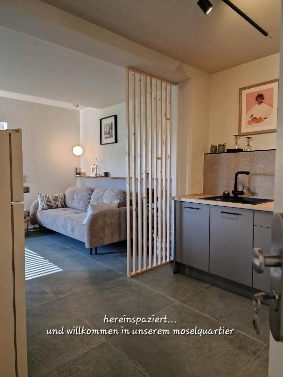 a living room with a bed and a kitchen at moselquartier terlinden- Apartment in Besch