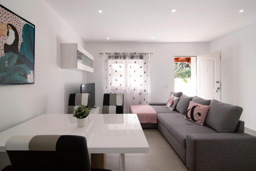 a living room with a couch and a table at Adelino Guest House in Olhão