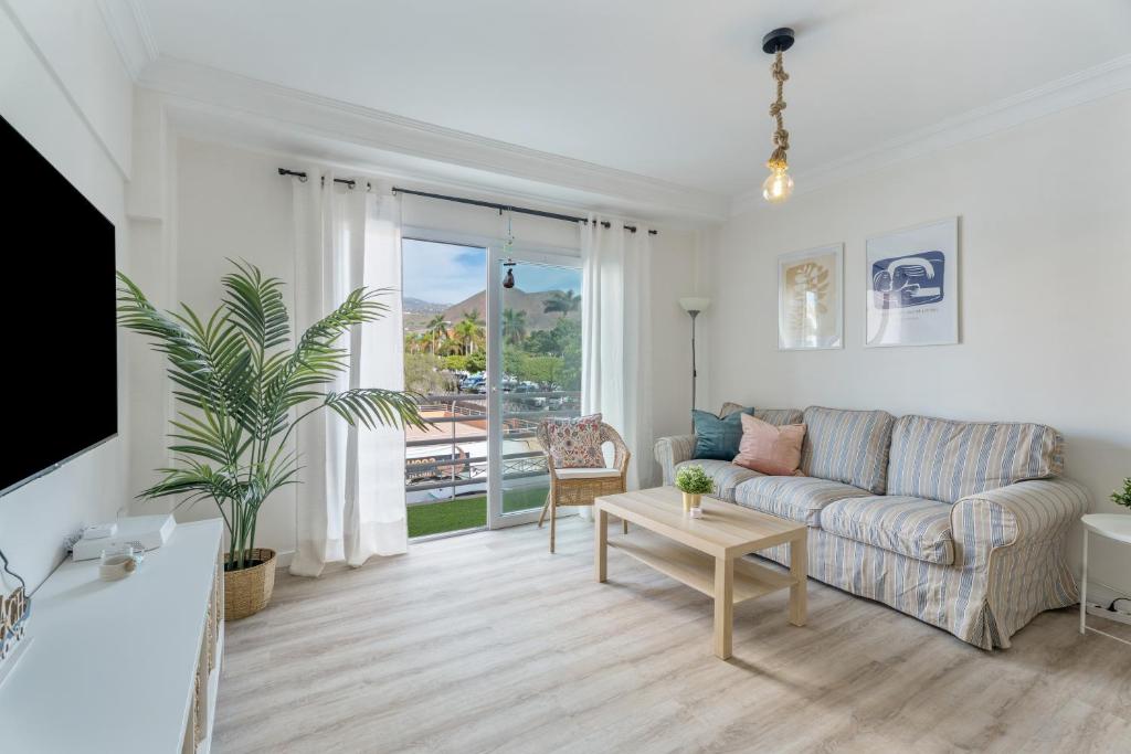 a living room with a couch and a table at Apartamento Marte Centro in Los Cristianos