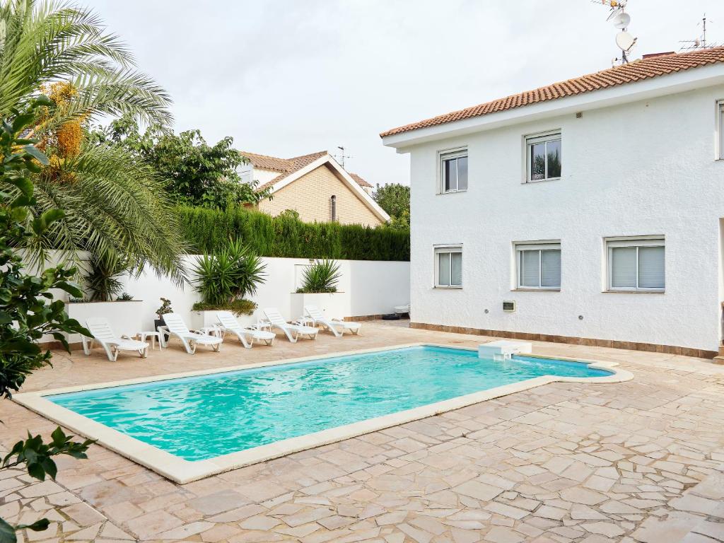 a swimming pool in front of a house at Naizan in L'Ametlla de Mar