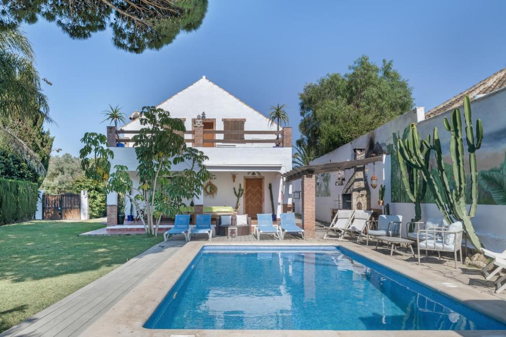 a villa with a swimming pool and a house at El Rincon del Che in Zahora