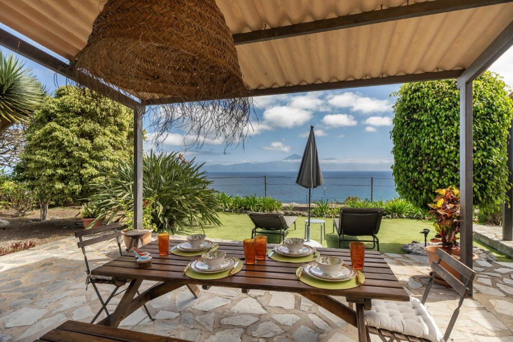 a wooden table with plates of food on a patio at Casa La Bobadilla in Agulo