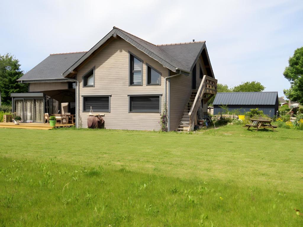 a house with a large yard in front of it at Les Hirondelles du Cap in Plévenon