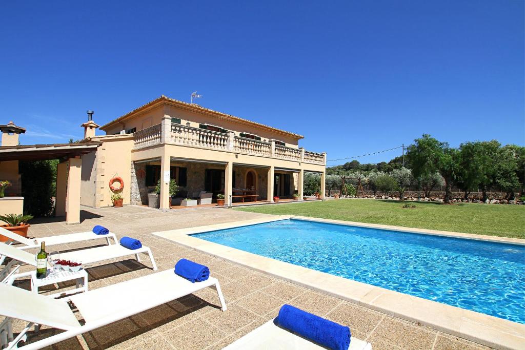 a villa with a swimming pool and a house at Can Seguinot in Pollença