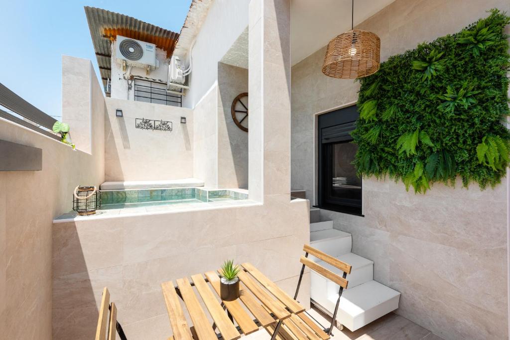a patio with a wooden table and chairs at La Mihilla in Málaga