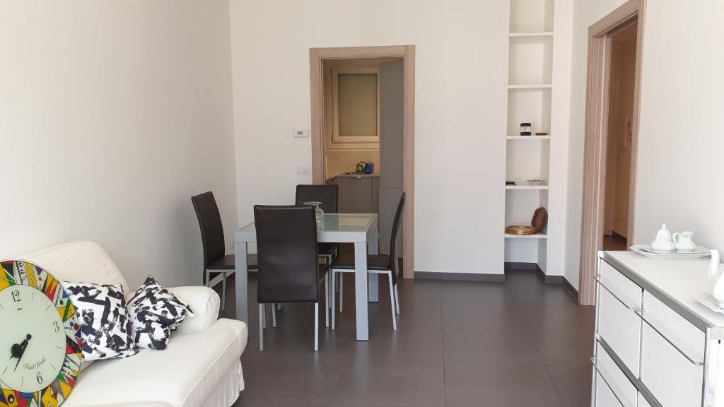 a living room with a couch and a table at Modern apartament in Porlezza
