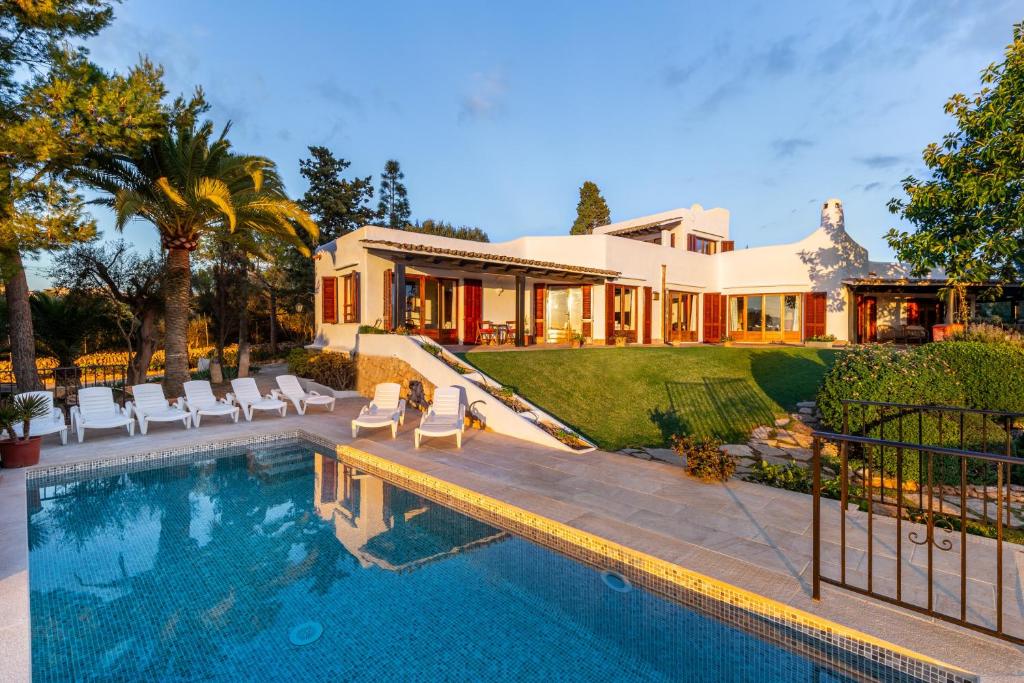 a house with a swimming pool in front of a house at Bon Viure in Marratxí 