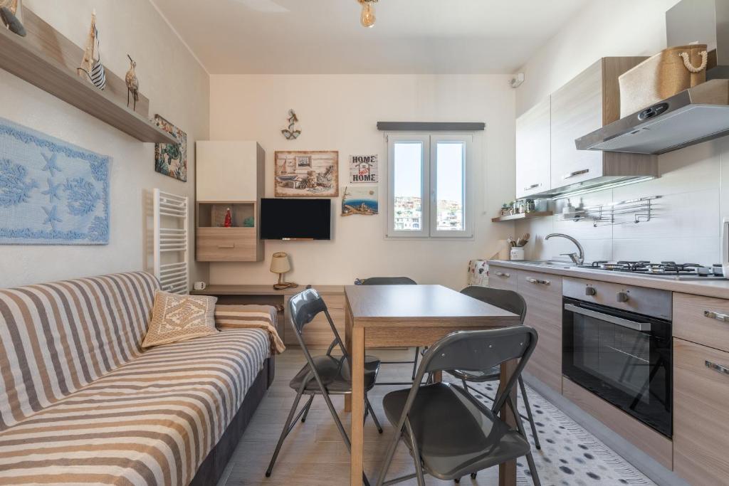 a living room with a couch and a table at Gemma Piccolino in Villasimius