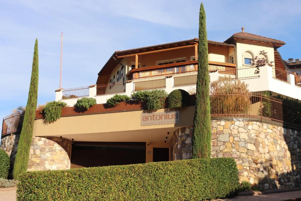 a building with trees in front of it at Landhaus Antonius Eppan in Appiano sulla Strada del Vino