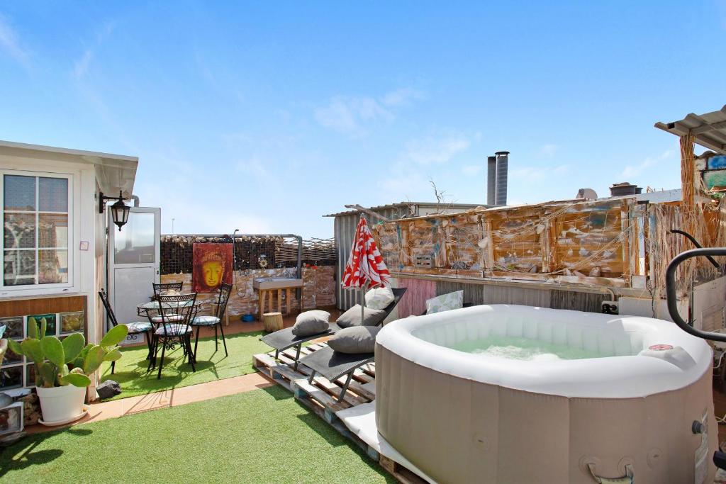 a hot tub sitting on a patio on a roof at Casa Siryo in Castillo del Romeral