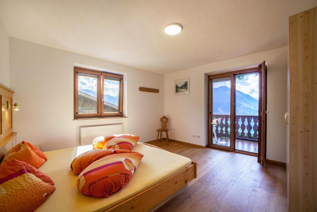 a bedroom with a bed with pillows on it at Fichtenhof Wohnung Edelweiss in Tarces