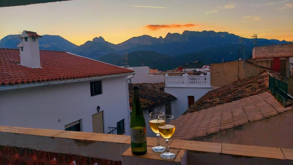 a couple of glasses of wine sitting on a balcony at Amarilla in Callosa d'en Sarrià