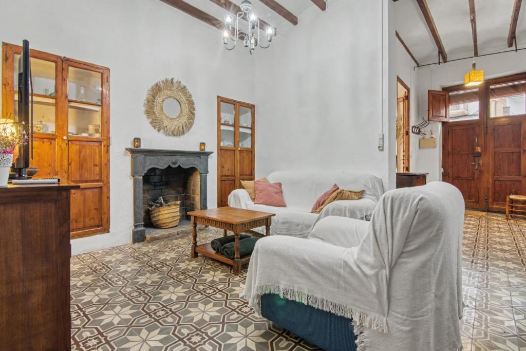 a living room with two couches and a fireplace at La casa de la Sariera in Jávea