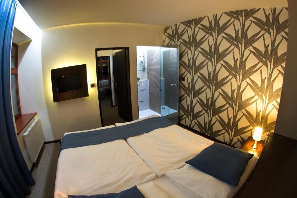 Postel nebo postele na pokoji v ubytování Hotel Slunný Dvůr