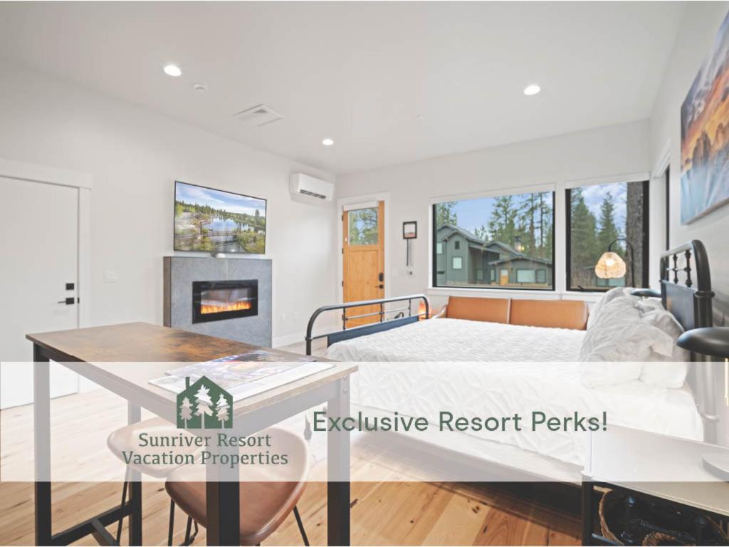 a bedroom with a bed and a fireplace at 18136-2 Forestbrook Loop in Bend