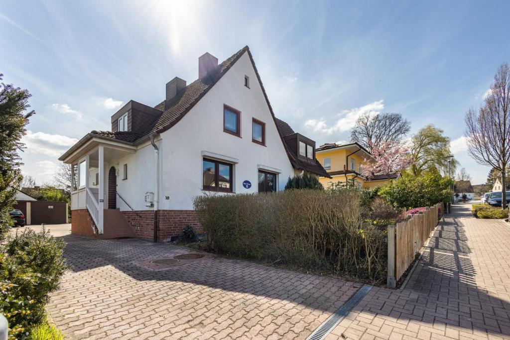 a white house with a brown roof at Ostseekind in Timmendorfer Strand
