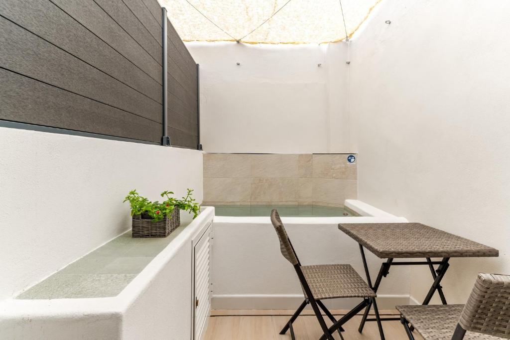 a bathroom with a tub with a table and chairs at Cala Azul-few steps from the beach in La Cala de Mijas