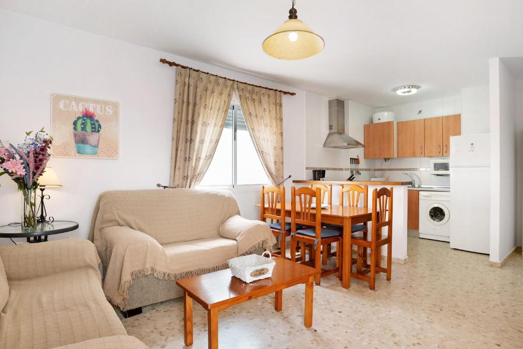a living room with a couch and a table at Sagasta 1 - Andalmar in Conil de la Frontera