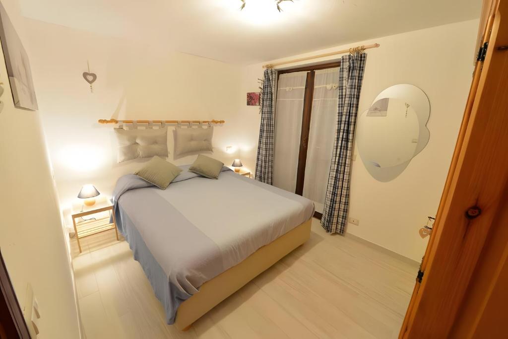 a bedroom with a large bed in a room at Maison Wanda La Salle in La Salle
