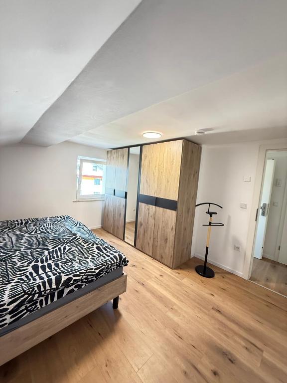 a bedroom with a bed and a wooden floor at Ferienwohnung Kastellaun in Kastellaun