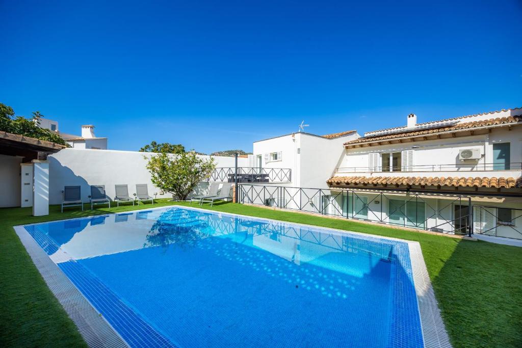a large swimming pool in the backyard of a house at Ca Nostra in Port d'Andratx