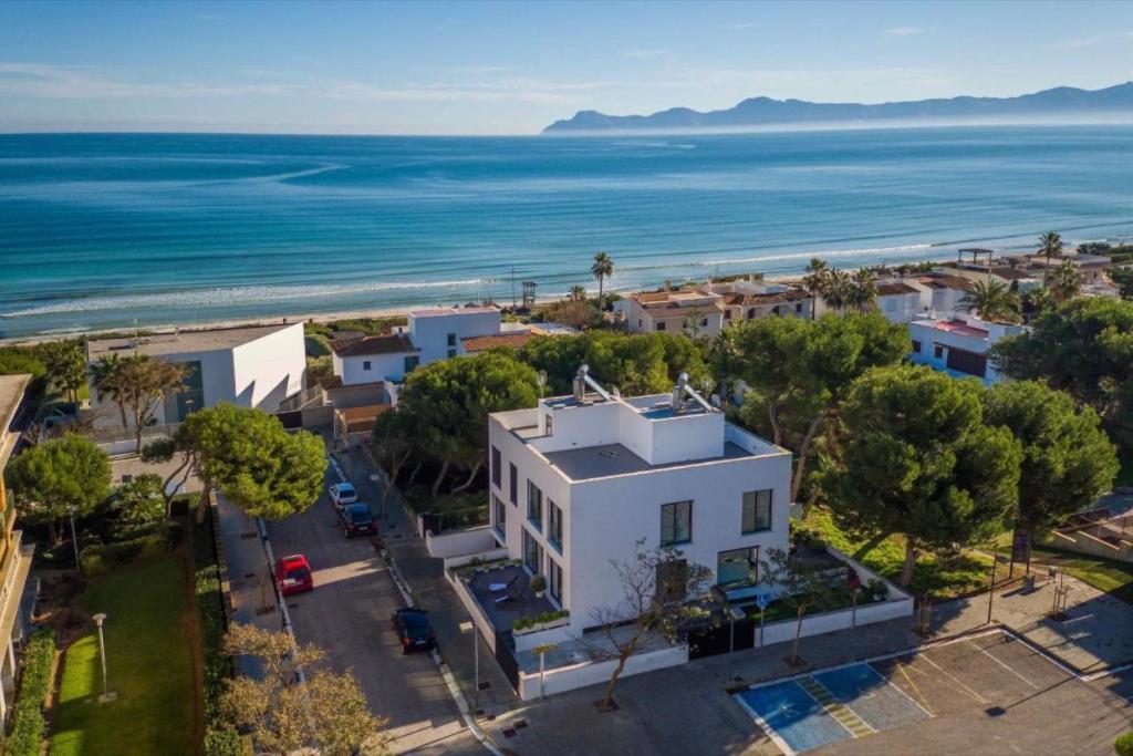 an aerial view of a white building and the ocean at Naturamar in Muro