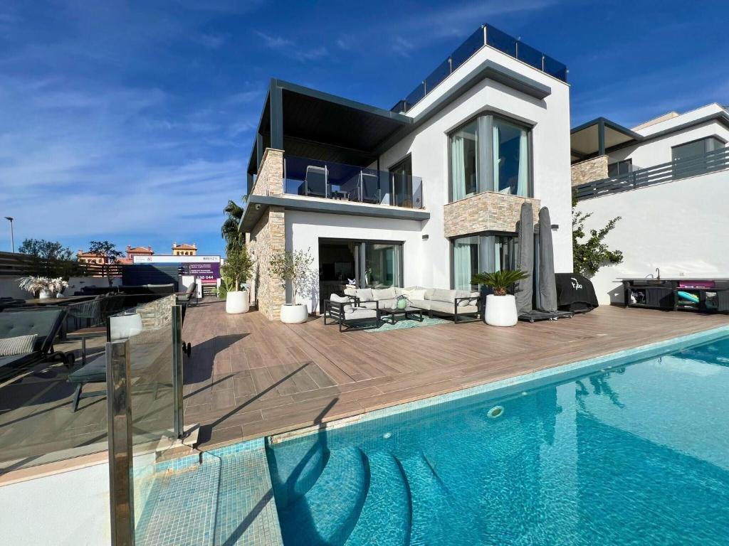 a house with a swimming pool in front of a house at Barcelona 11 in Finestrat
