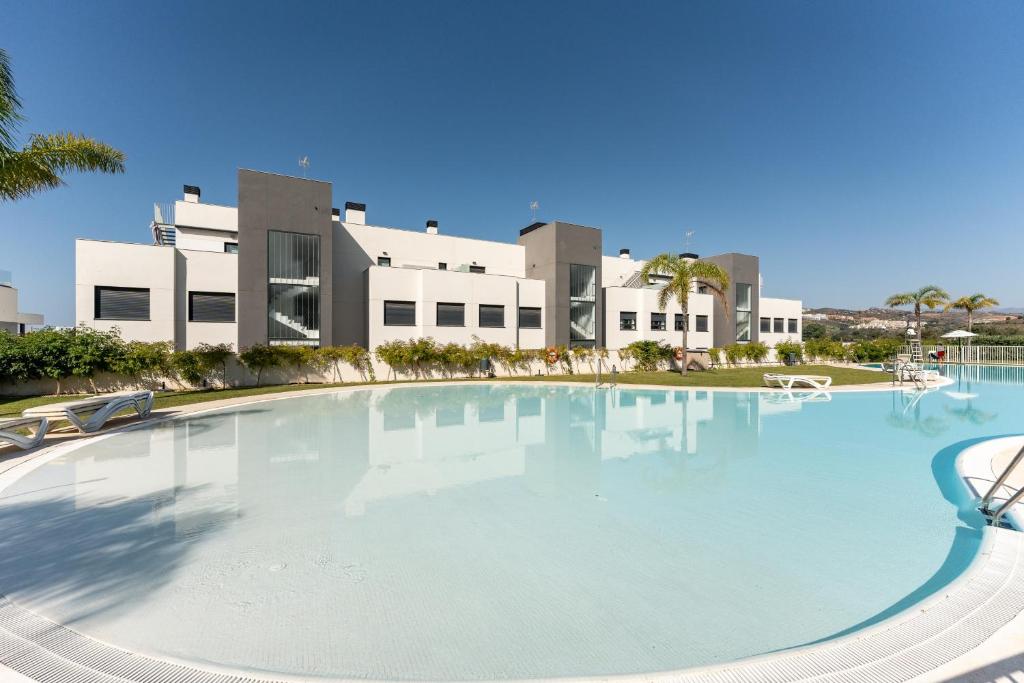 a large swimming pool in front of a building at 250 La Cala Calaserena in La Cala de Mijas