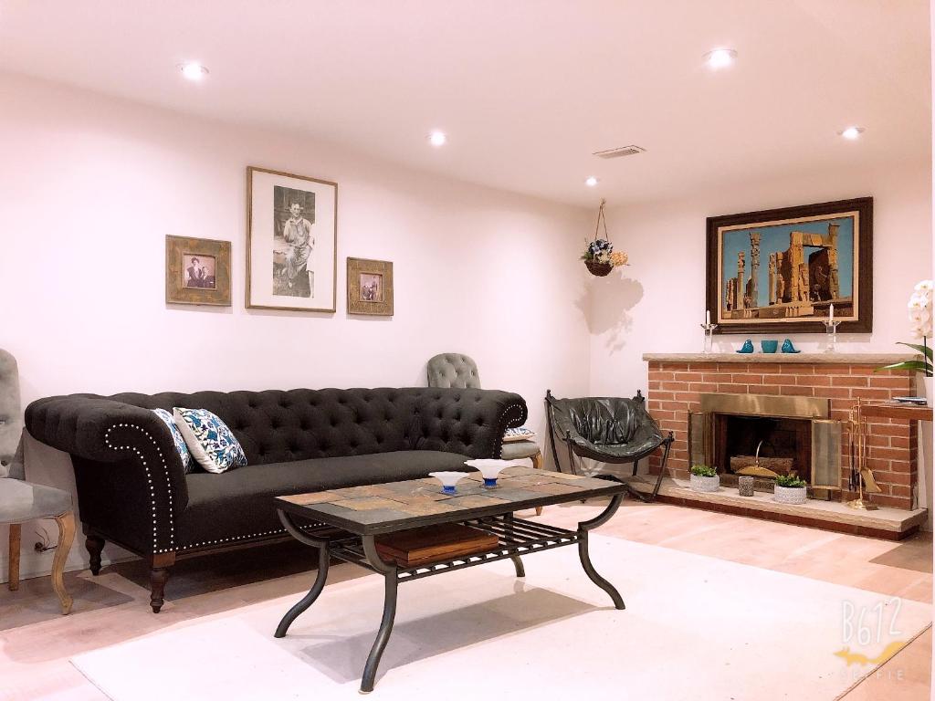 a living room with a couch and a fireplace at Cozy 2bedroom Basement unit in Toronto