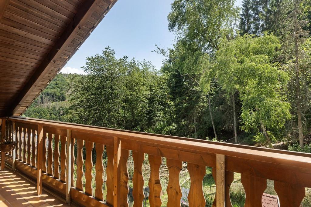 a deck with a view of the woods at Wohung zum Ausblick in Plettenberg