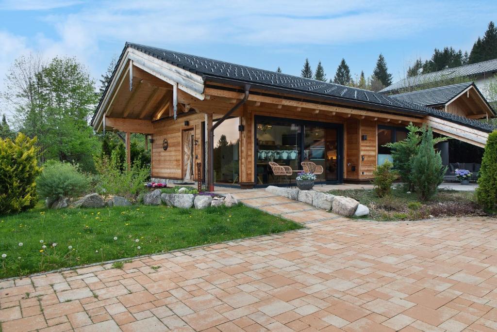 a house with a pavilion with a brick patio at Alpenchalet 19 in Krün
