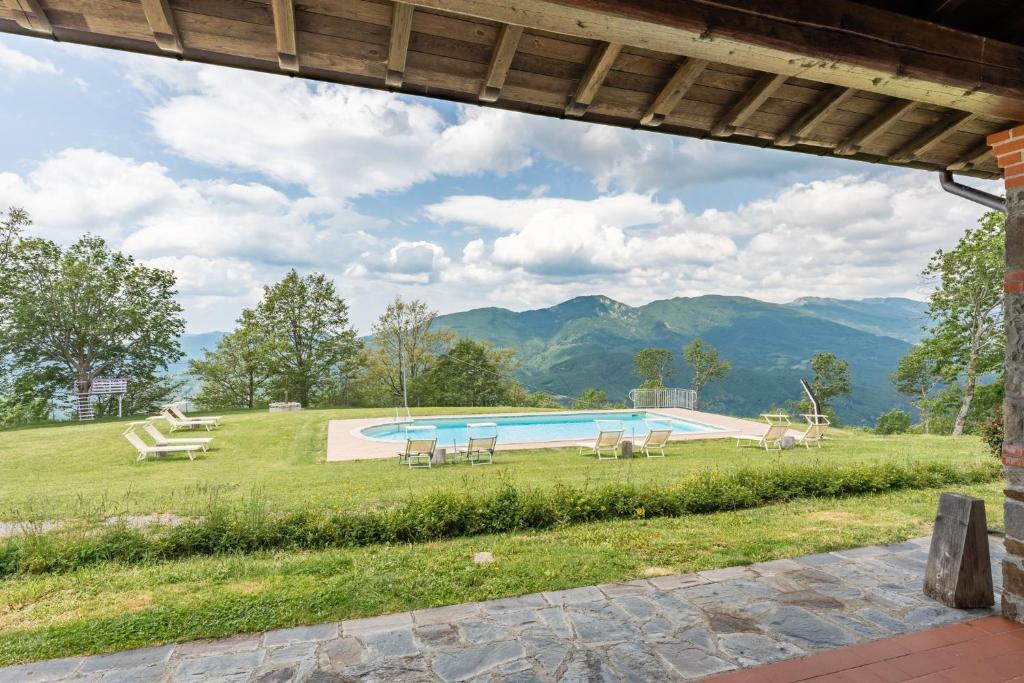 a view of a swimming pool with mountains in the background at Il Serrino 4 in Pistoia