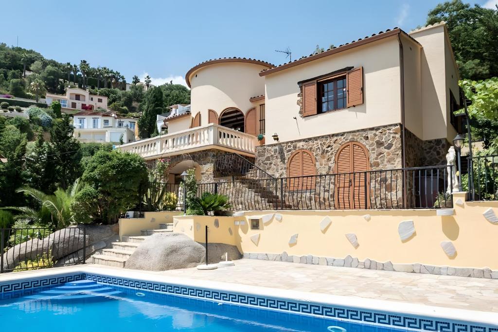 a house with a swimming pool in front of it at Casa Terra de Chispa by Easy Brava in Calonge