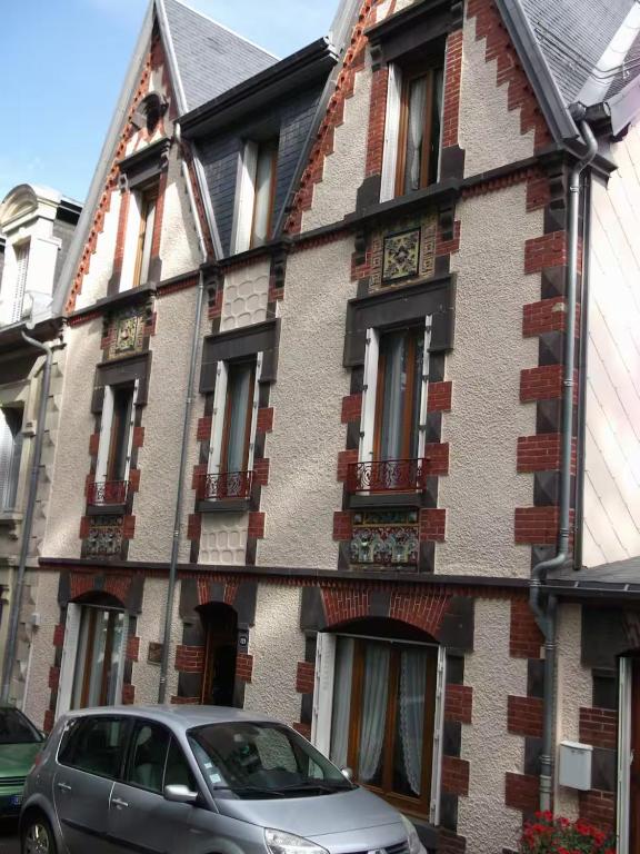 a house with a car parked in front of it at Villa Eugénie in La Bourboule