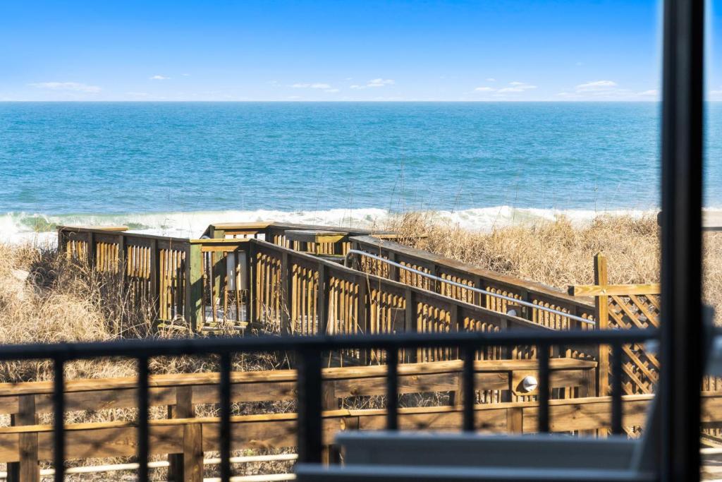 a view of the ocean from a window at Boardwalk Breeze Oceanfront Pool Villa in Carolina Beach