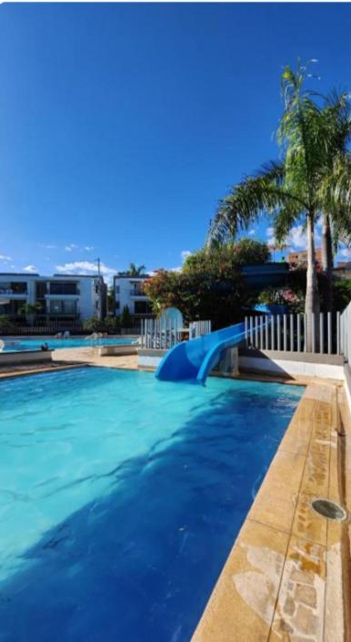 a large swimming pool with a blue slide at Alojamiento Santa Fe de Antioquia in Santa Fe de Antioquia