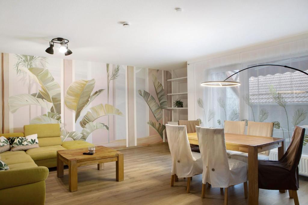 a living room with a table and a couch at Happy Place in Ilmenau