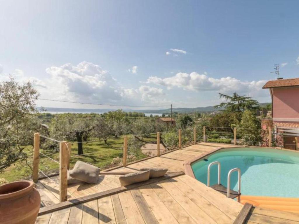 a swimming pool on a wooden deck with a view at Il Giardino Etrusco Bolsena in Bolsena