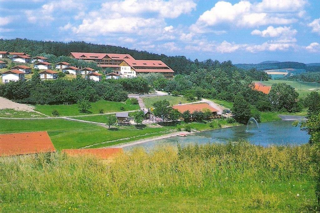a view of a town with a river and houses at Rhön Residence in Dipperz