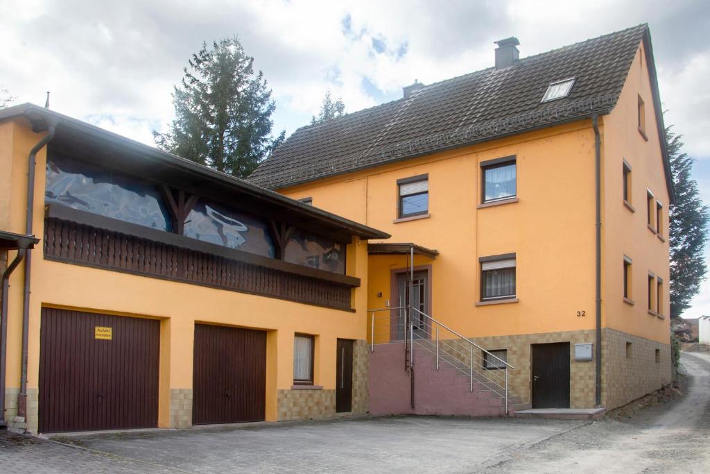 a large orange building with a garage at Gemütliche Ferienhaus am Main in Gemünden