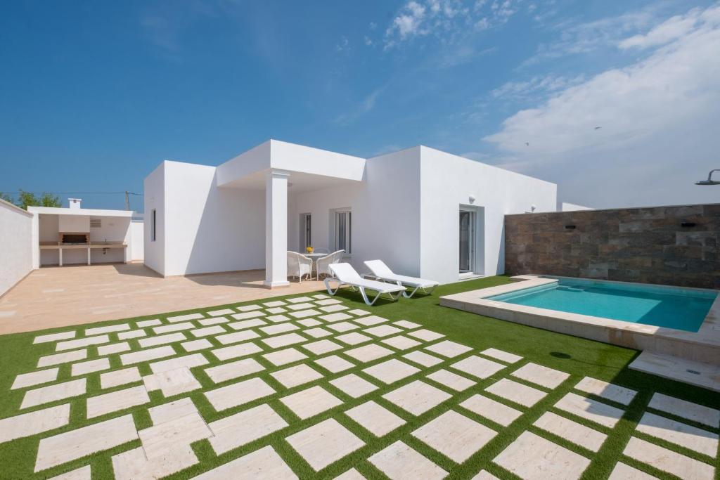 a villa with a swimming pool and a house at Casa El Palmar 2 in Vejer de la Frontera